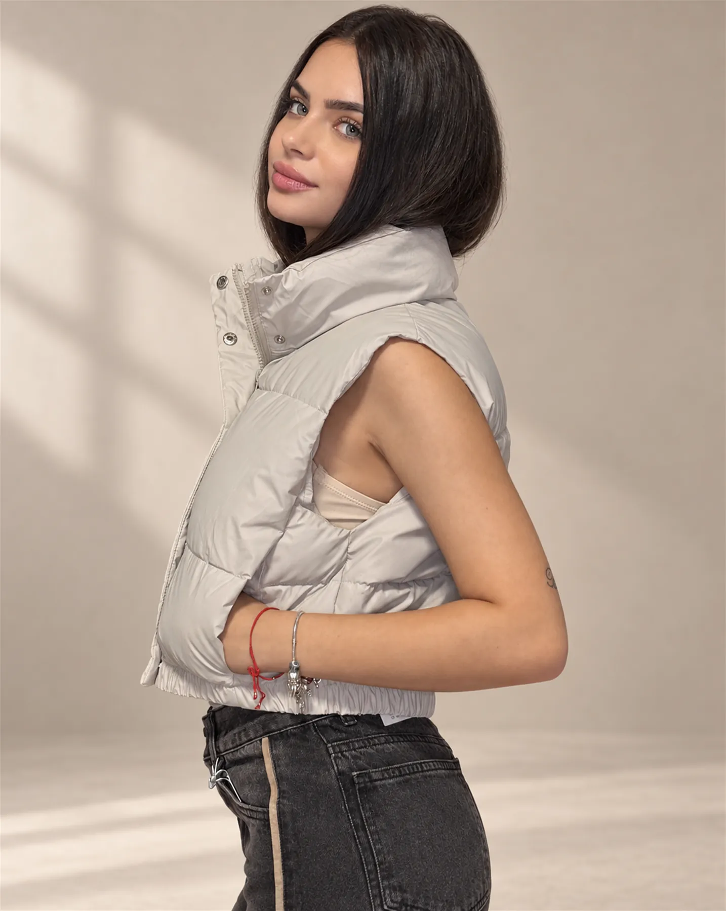 The Cropped Puffer Vest in Ecru, Three-quarter